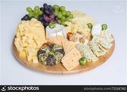 Cheese plate variation on white background.. Cheese plate variation on white background