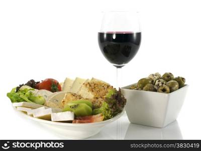 cheese plate with red wine and olives on white background