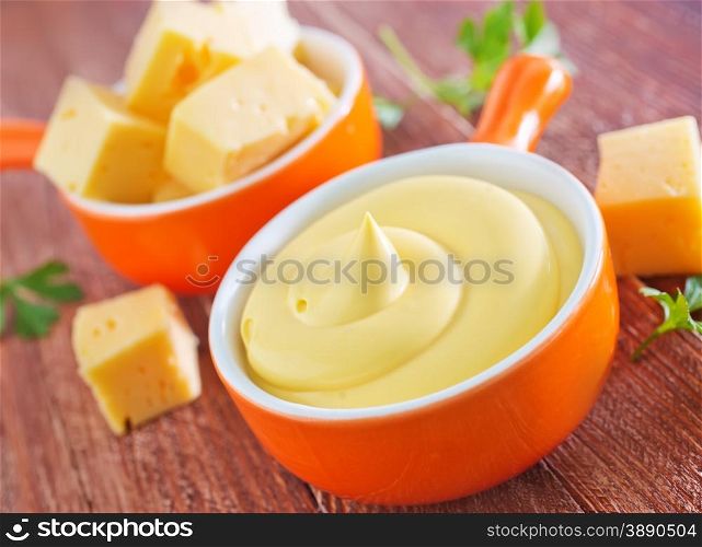 cheese sauce in bowl and on a table