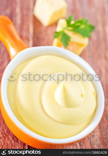 cheese sauce in the bowl and on a table