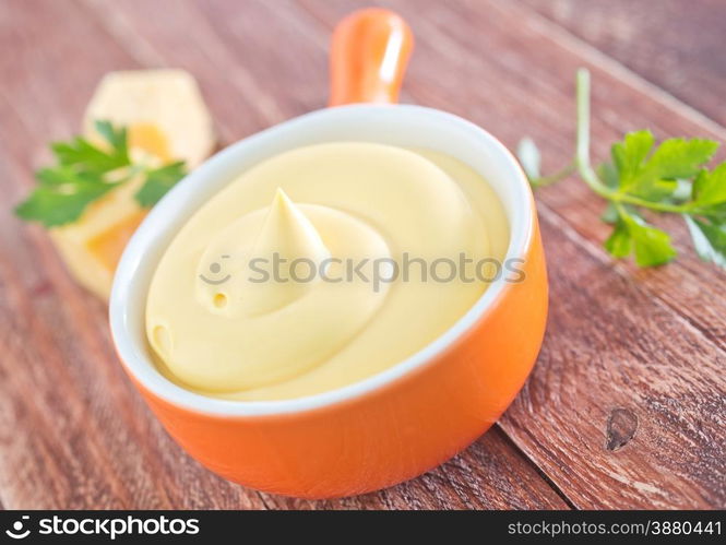 cheese sauce in the bowl and on a table