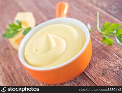 cheese sauce in the bowl and on a table