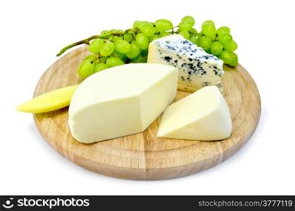 Cheese with fungus, suluguni, a bunch of grapes, a knife on a round wooden board isolated on white background