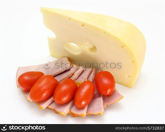 Cheese with holes and red tomatoes lie on a white background