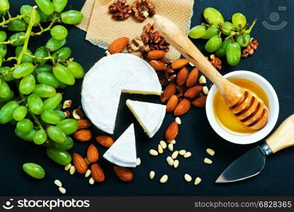 cheese with honey and nuts on a table