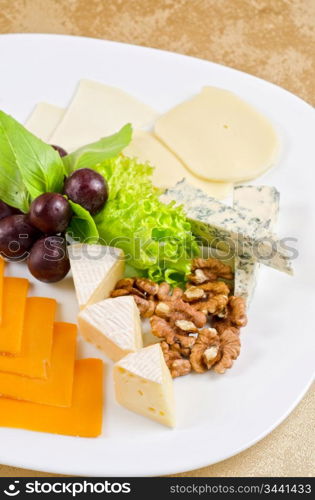 cheese with lettuce, grapes and nuts closeup