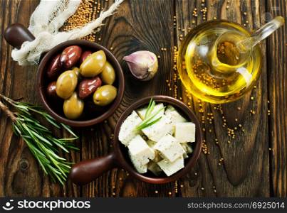 cheese with spice and olives on a table
