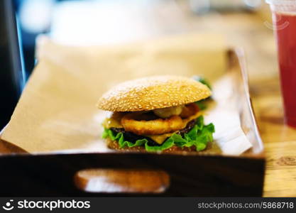 Cheeseburger on sesame buns and drink