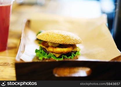 Cheeseburger on sesame buns and drink