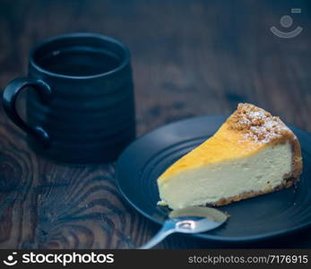 Cheesecake on black plate and coffee