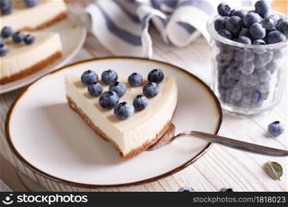 cheesecake with blueberry on a white wooden background