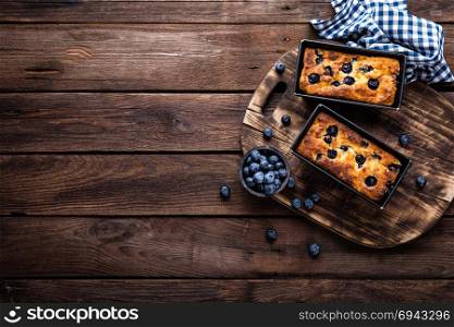 Cheesecake with blueberry on wooden background, top view