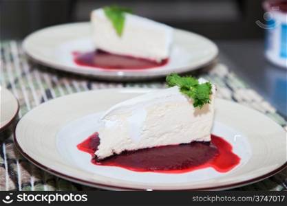 cheesecake with cream in berry jam