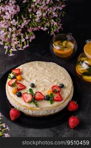 cheesecake with poppy seeds decorated with fresh strawberries