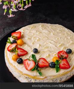 cheesecake with poppy seeds decorated with fresh strawberries