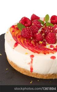 Cheesecake with raspberriees, plum and mint leaves isolated on ehite background