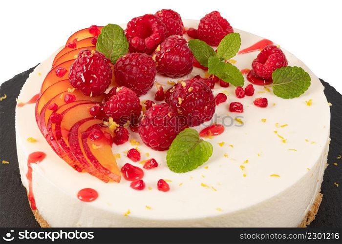 Cheesecake with raspberriees, plum and mint leaves isolated on white background