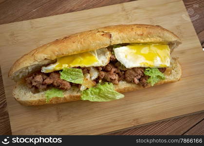 Cheesesteak - sandwich combining frizzled beef, onions, and cheese in a small loaf of bread