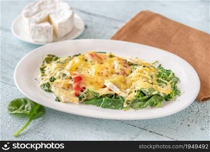 Cheesy baked eggs with spinach and tomato