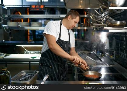 Chef adding pepper spice to sauce with tomato. Italian pasta cooking at traditional restaurant. Chef adding pepper to sauce with tomato for pasta