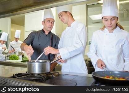 Chef advising cookery student
