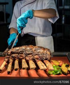 Chef Carving prime rib of roast Wagyu beef