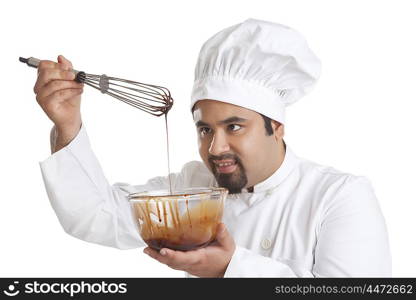 Chef checking chocolate from bowl