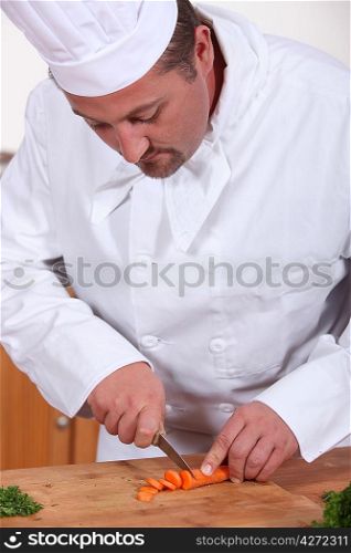 Chef chopping a carrot