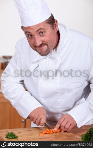 Chef chopping a carrot