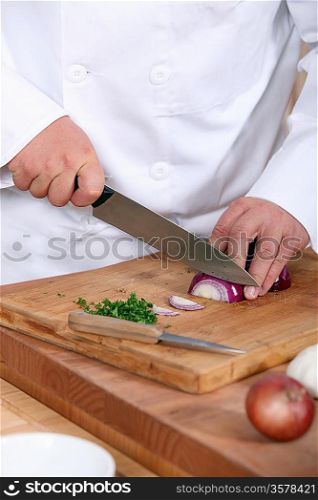Chef chopping an onion