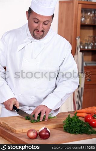 Chef chopping fresh herbs