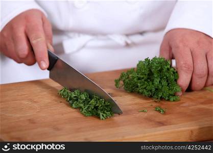 Chef chopping parsley