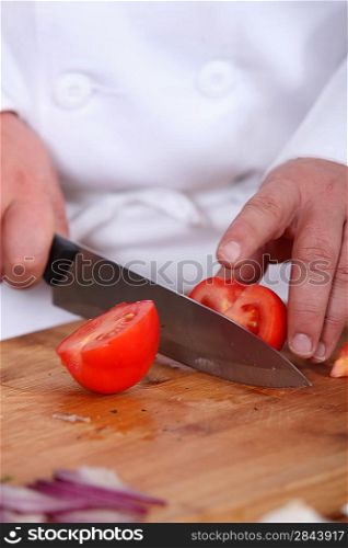 Chef chopping tomato