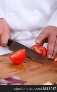 Chef chopping tomato