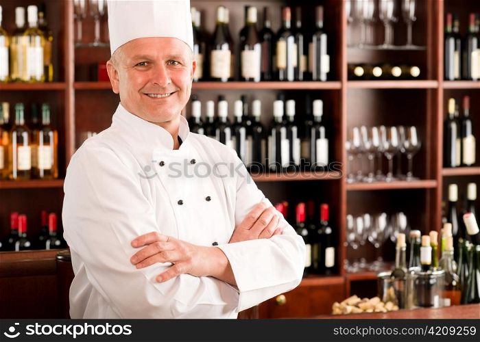 Chef cook confident professional posing in restaurant cross arms
