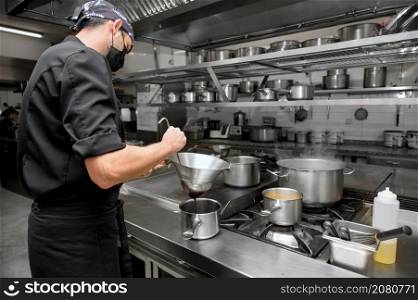 Chef cooking in modern industrial kitchen. High quality photo. Chef cooking in modern industrial kitchen.