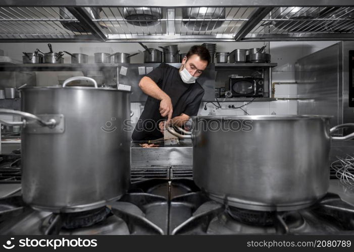 Chef cooking in modern industrial kitchen. High quality photo. Chef cooking in modern industrial kitchen.