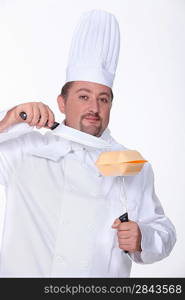 chef cutting a hamburger box with a big knife