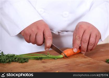 chef cutting carrots
