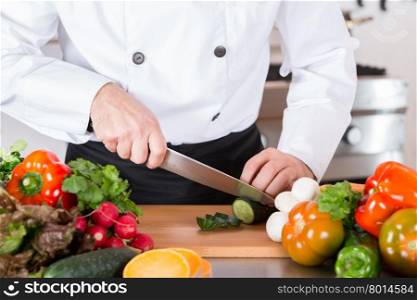 Chef cutting fresh and delicious vegetables for cooking
