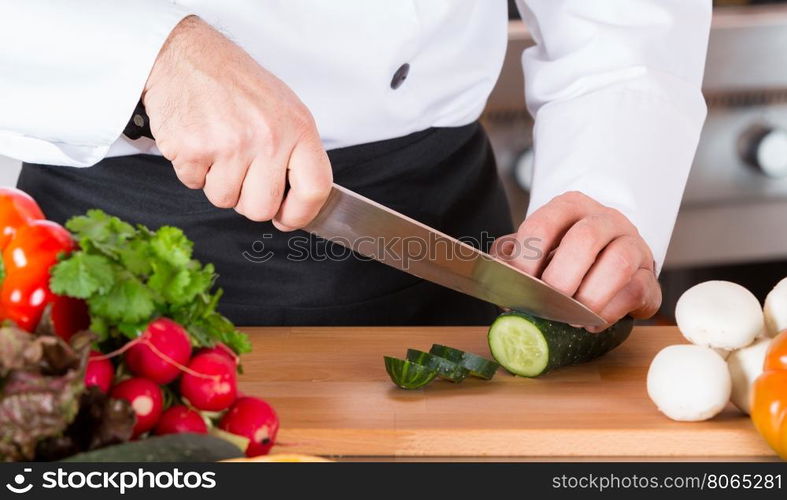 Chef cutting fresh and delicious vegetables for cooking