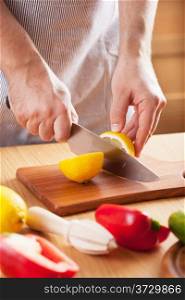 chef cutting lemon