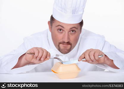 Chef eating a polystyrene foam takeaway box