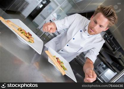 chef garnishing a plate