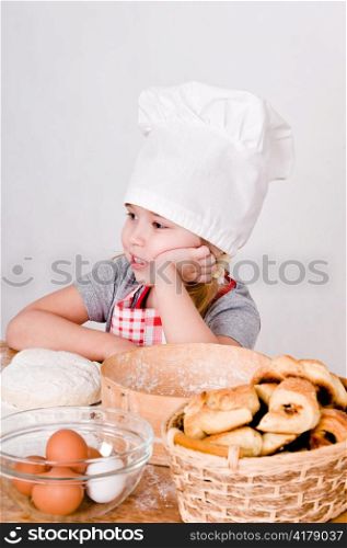 Chef Girl sitting at the table and thinks