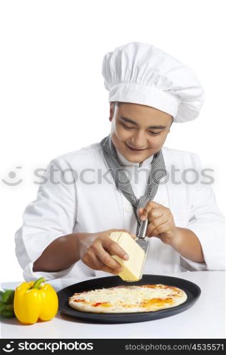 Chef grating cheese on pizza