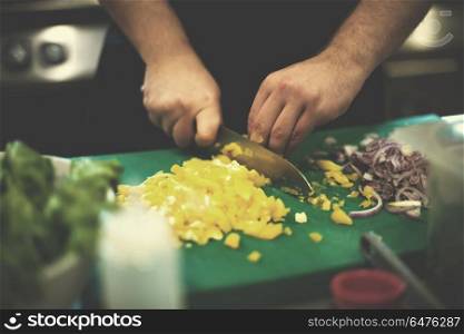 Chef hands cutting fresh and delicious vegetables for cooking or salad. Chef hands cutting fresh and delicious vegetables