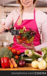 Chef happy woman holding shopping basket with diet sign and many colorful vegetables. Healthy eating lifestyle, vegetarian food.. Woman holding shopping backet with vegetables