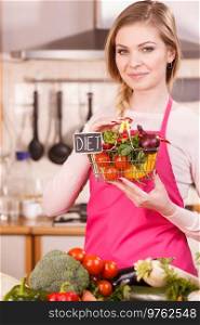 Chef happy woman holding shopping basket with diet sign and many colorful vegetables. Healthy eating lifestyle, vegetarian food.. Woman holding shopping backet with vegetables