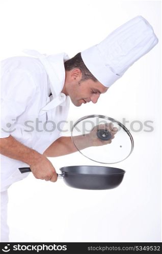 chef holding a frying pan